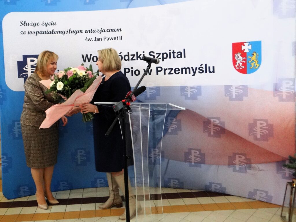 przewodnicząca izby pielęgniarskiej Marzanna Pelc składa kwiaty na ręce dyrektorki Barbary Stawarz