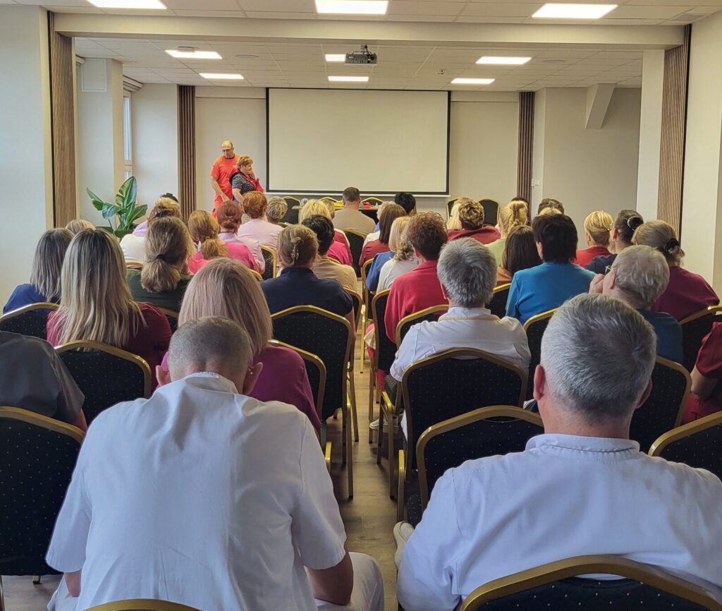 sala pełna ludzi, w tle widać ratownika prowadzącego warsztaty